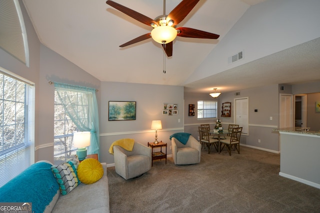 sitting room with ceiling fan, high vaulted ceiling, and carpet floors