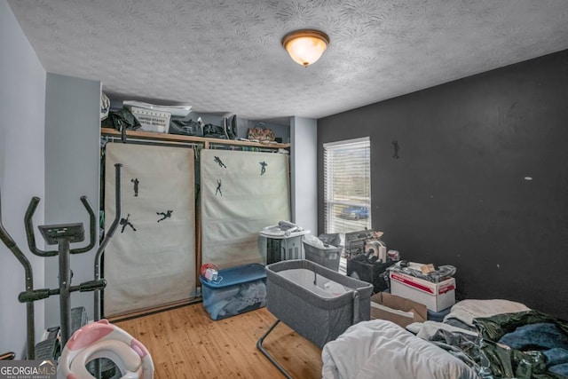 bedroom featuring hardwood / wood-style flooring and a textured ceiling