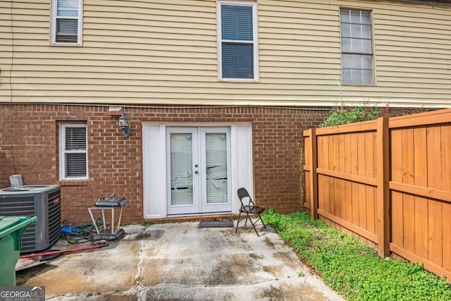 rear view of property with central AC, french doors, and a patio area