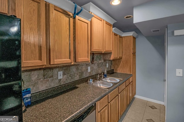 kitchen with sink, dishwasher, black fridge, decorative backsplash, and light tile patterned flooring