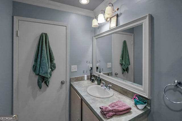 bathroom with vanity and ornamental molding