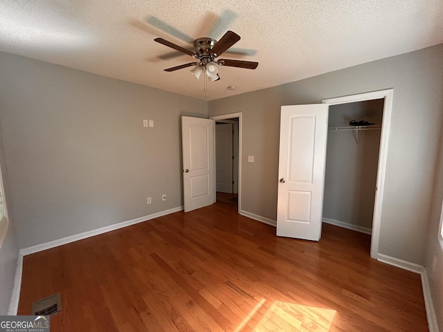 47 Elm St, Hampton, GA 30228 - unfurnished bedroom featuring light wood-style flooring, a closet, baseboards, a ceiling fan, and a textured ceiling