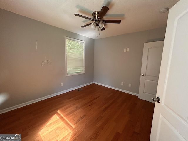 47 Elm St, Hampton, GA 30228 - spare room with dark wood-type flooring, a ceiling fan, and baseboards