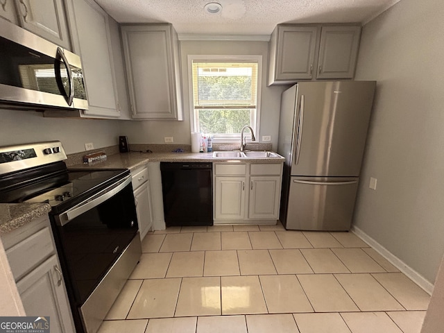 47 Elm St, Hampton, GA 30228 - kitchen with stainless steel appliances, a sink, gray cabinetry, light countertops, and a textured ceiling