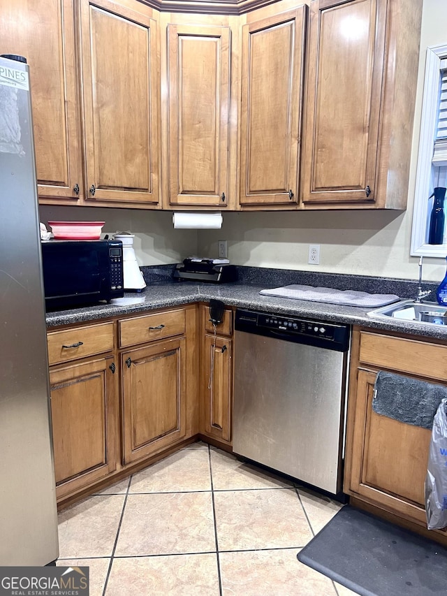 540 Pinegrove Dr, Dublin, GA 31021 - kitchen with appliances with stainless steel finishes, sink, and light tile patterned floors