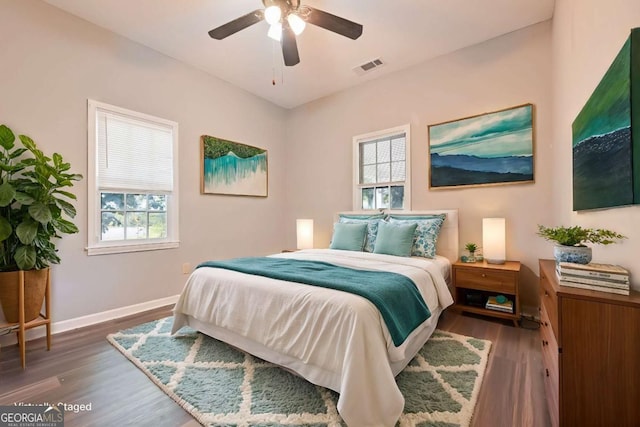 bedroom with ceiling fan and dark wood-type flooring