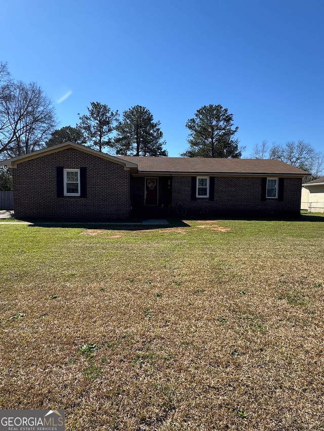 single story home with brick siding and a front lawn