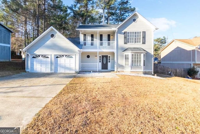 view of property featuring a balcony and a garage