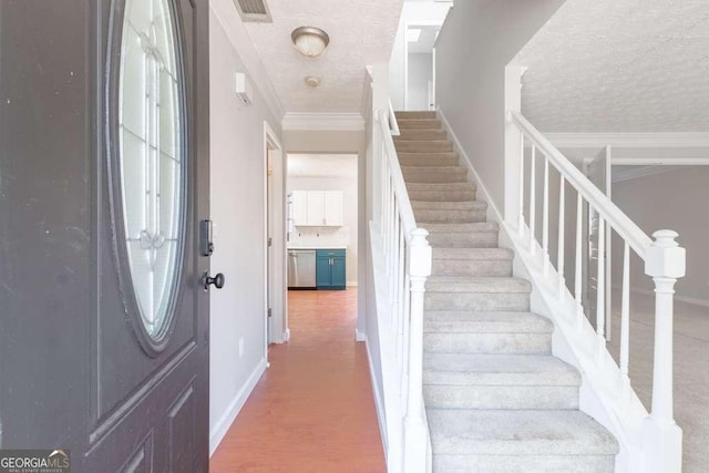 foyer entrance with crown molding and a textured ceiling