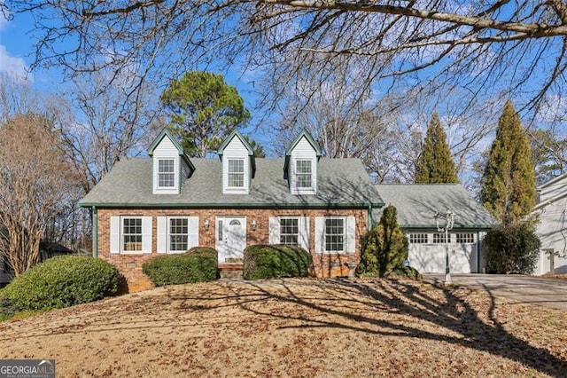 cape cod-style house with a garage