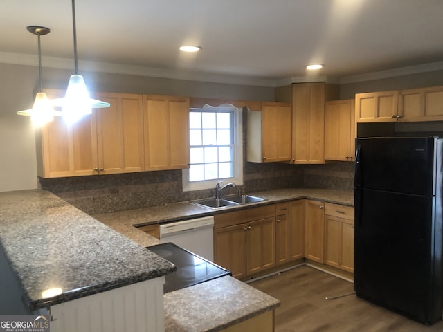 kitchen with tasteful backsplash, light brown cabinetry, black refrigerator, sink, and white dishwasher