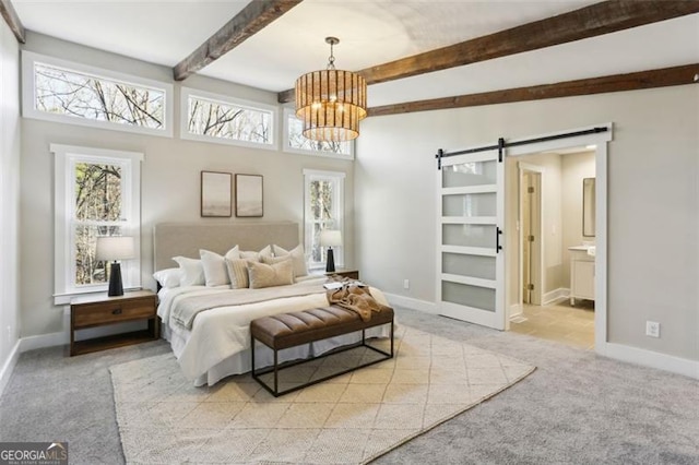 carpeted bedroom featuring beam ceiling, ensuite bath, a notable chandelier, and a barn door