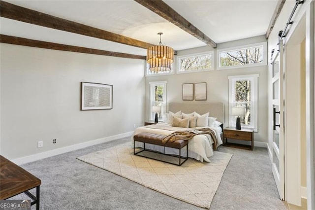 bedroom with a notable chandelier, a barn door, light colored carpet, and beamed ceiling