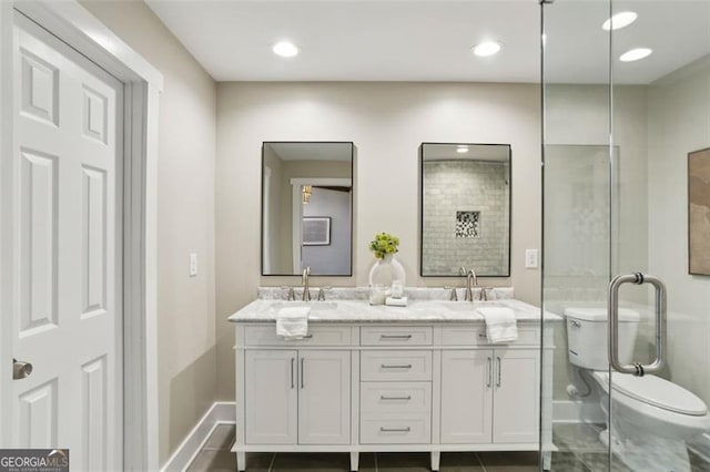 bathroom with vanity, toilet, and tile patterned floors