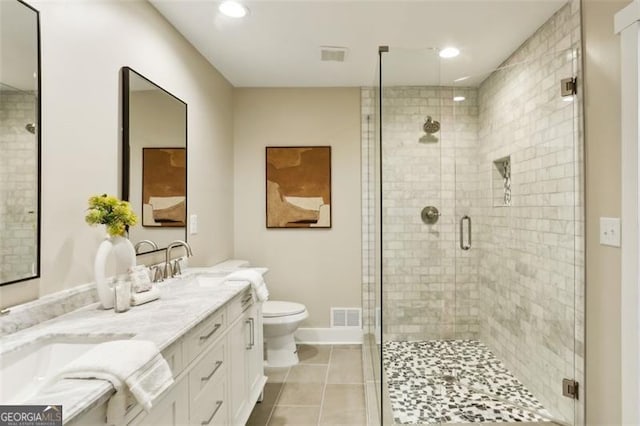 bathroom featuring tile patterned floors, toilet, a shower with door, and vanity