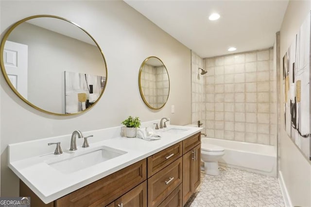 full bathroom with toilet, vanity, and tiled shower / bath