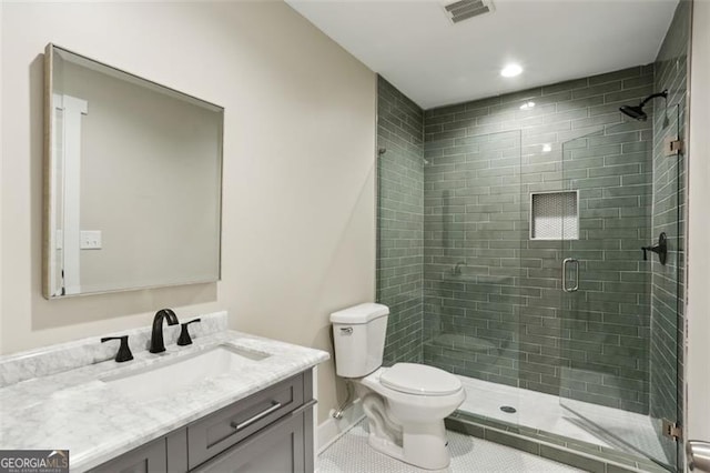 bathroom featuring toilet, vanity, tile patterned flooring, and an enclosed shower