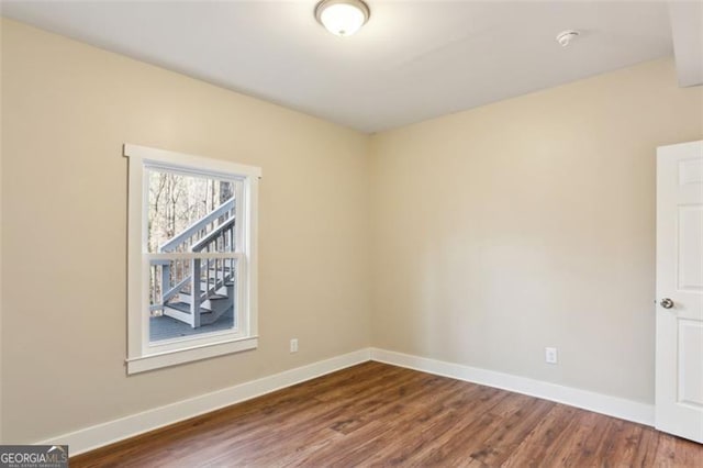 spare room featuring dark wood-type flooring