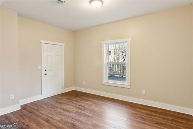 spare room with dark wood-type flooring