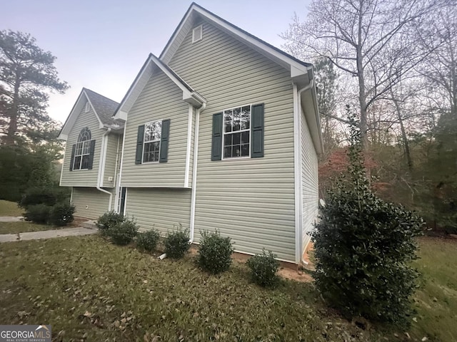 view of home's exterior with a yard