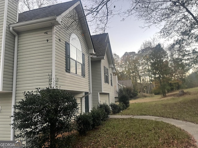 view of property exterior featuring a lawn