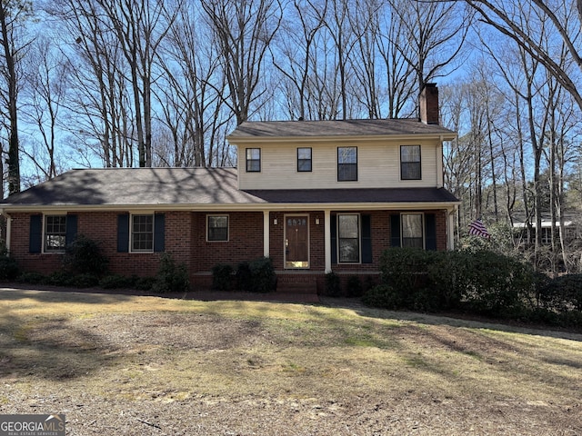 traditional-style house with brick siding and a chimney