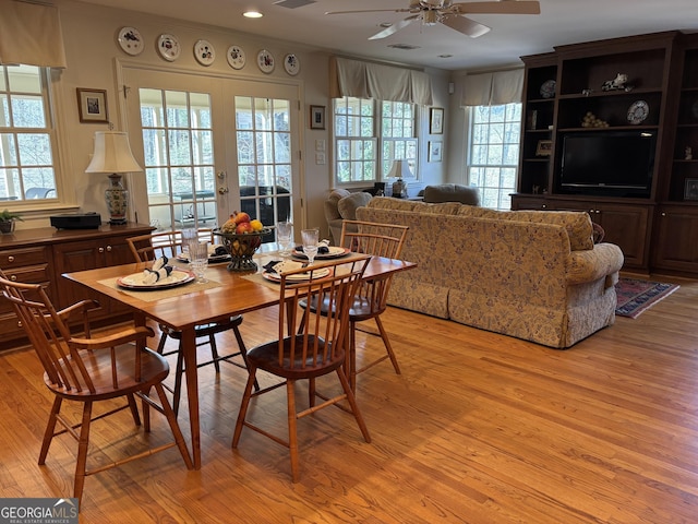 dining space featuring light wood-style floors, ceiling fan, ornamental molding, and french doors