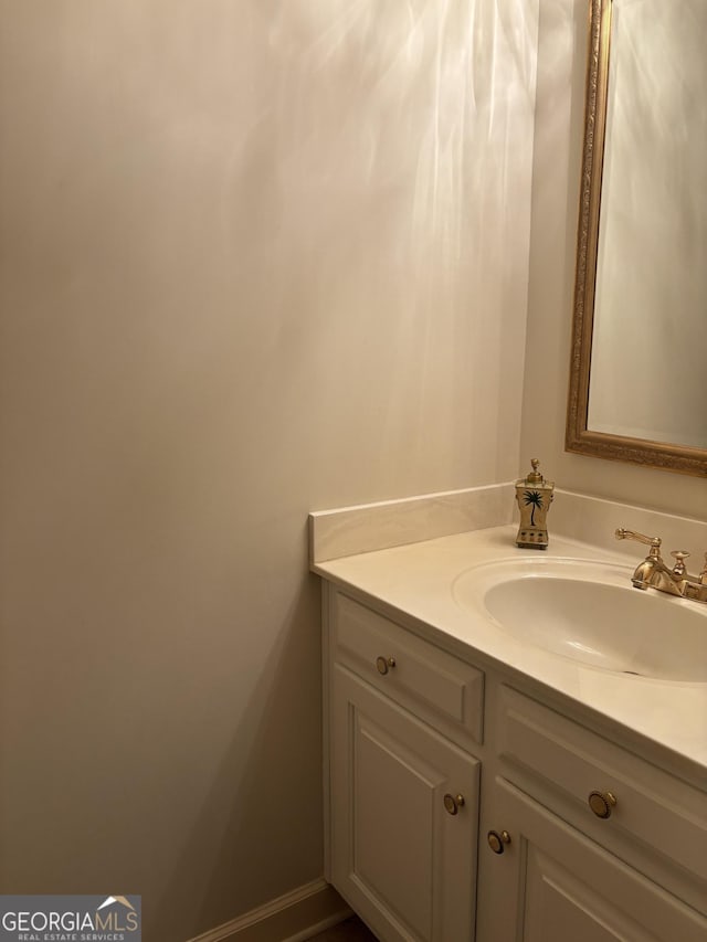 bathroom with baseboards and vanity