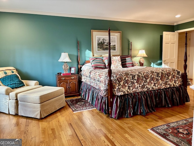 bedroom featuring wood finished floors and crown molding