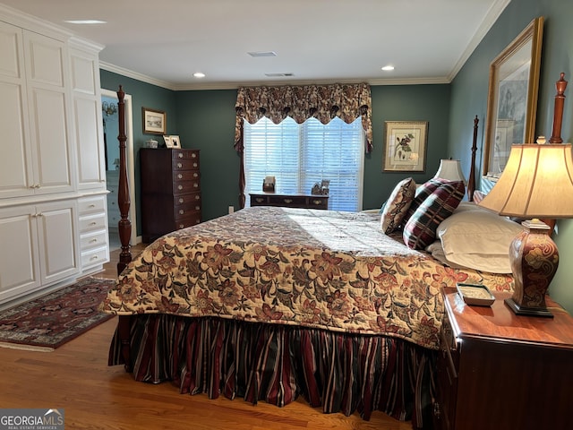 bedroom featuring visible vents, ornamental molding, wood finished floors, and recessed lighting