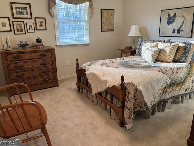 bedroom with light carpet and baseboards