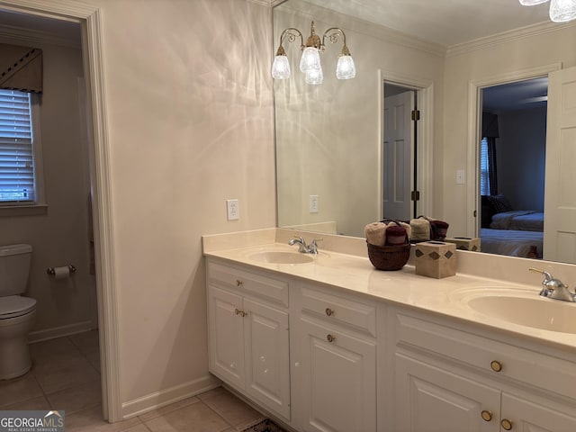 bathroom with ornamental molding, a sink, toilet, and tile patterned floors