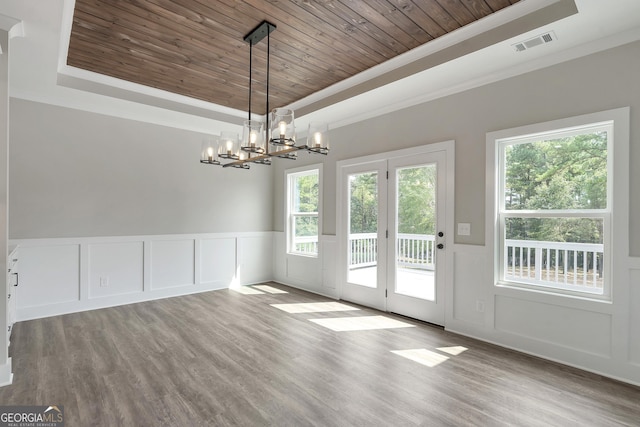 interior space featuring a tray ceiling, an inviting chandelier, wood-type flooring, and wooden ceiling