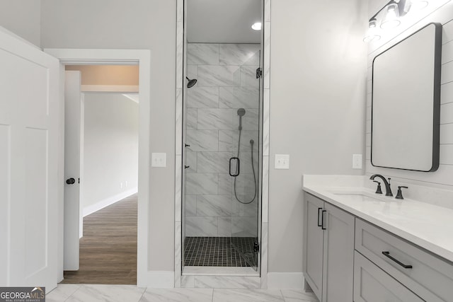 bathroom featuring vanity and a shower with shower door