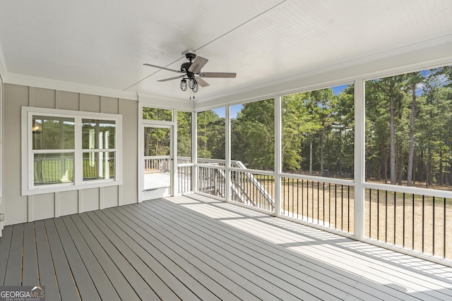 unfurnished sunroom featuring ceiling fan