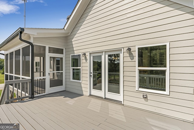 wooden deck featuring a sunroom