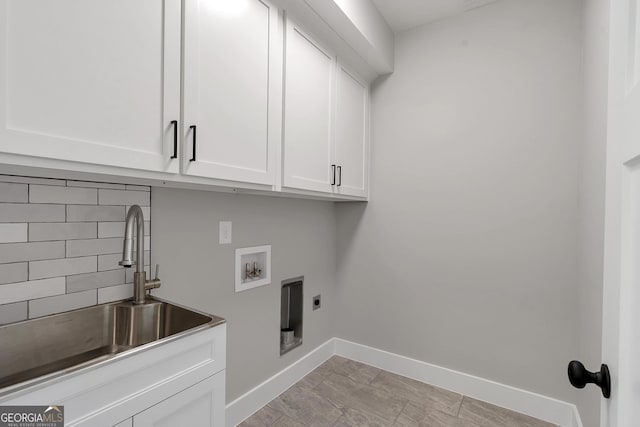 laundry area featuring cabinets, sink, electric dryer hookup, and hookup for a washing machine