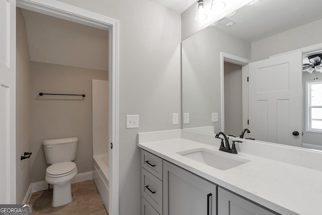 full bathroom featuring toilet, vanity, and shower / bathtub combination