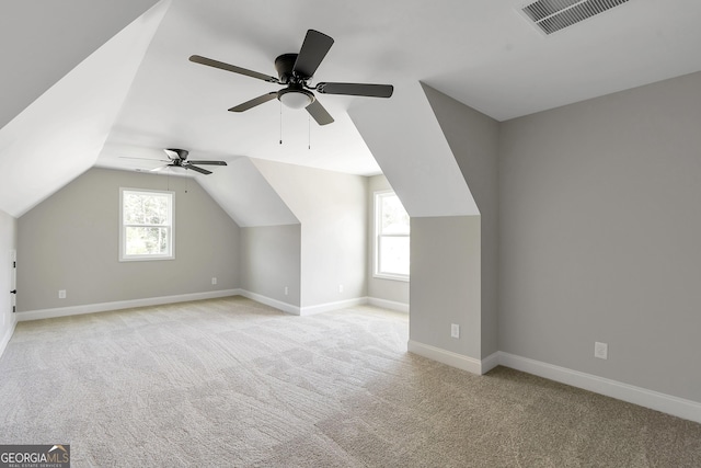 bonus room featuring light carpet, vaulted ceiling, and ceiling fan