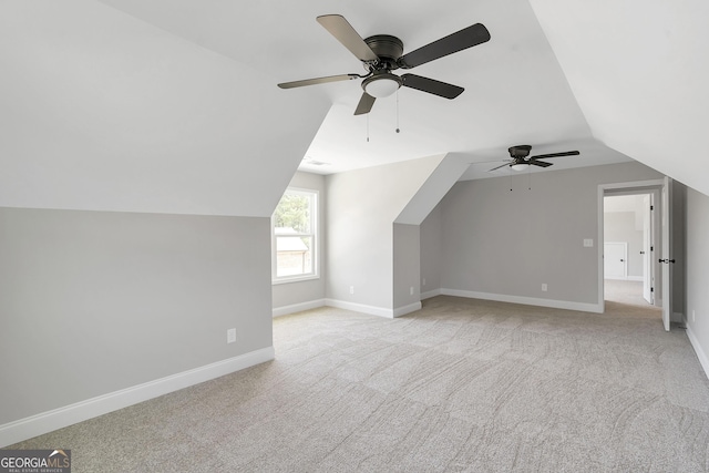 additional living space with vaulted ceiling and light colored carpet