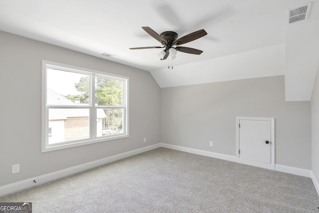 additional living space with ceiling fan, vaulted ceiling, and carpet floors