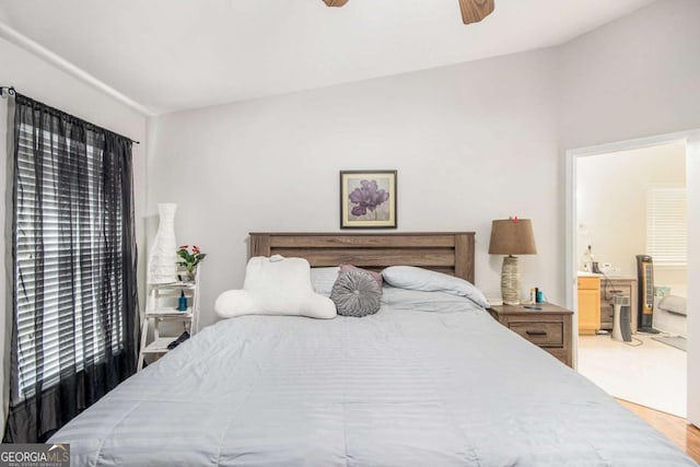 bedroom featuring ceiling fan and ensuite bath