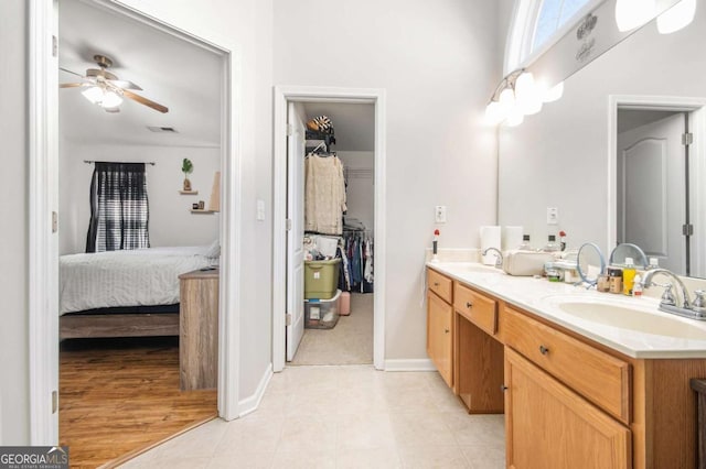 bathroom featuring tile patterned floors, vanity, and ceiling fan