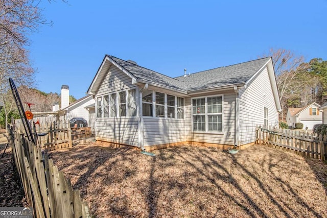 back of house featuring a sunroom