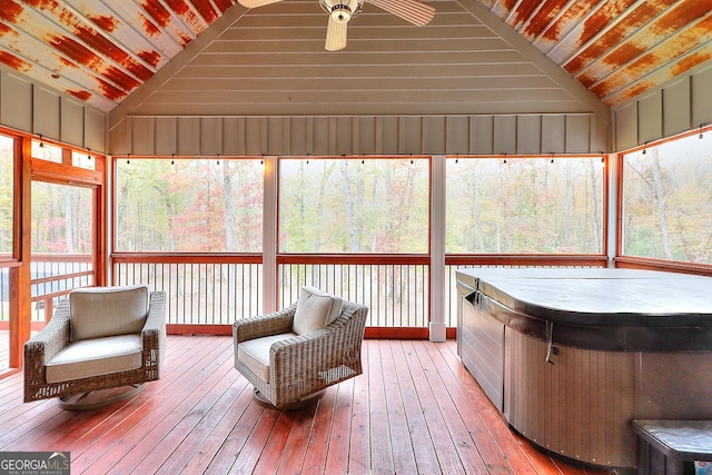 unfurnished sunroom with lofted ceiling, ceiling fan, and wooden ceiling