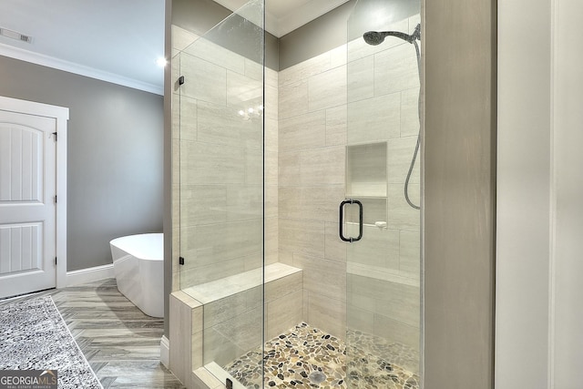 bathroom with separate shower and tub and ornamental molding