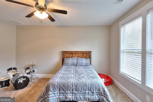 bedroom featuring carpet, multiple windows, and ceiling fan