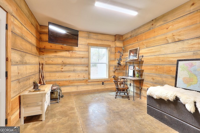 sitting room featuring wood walls