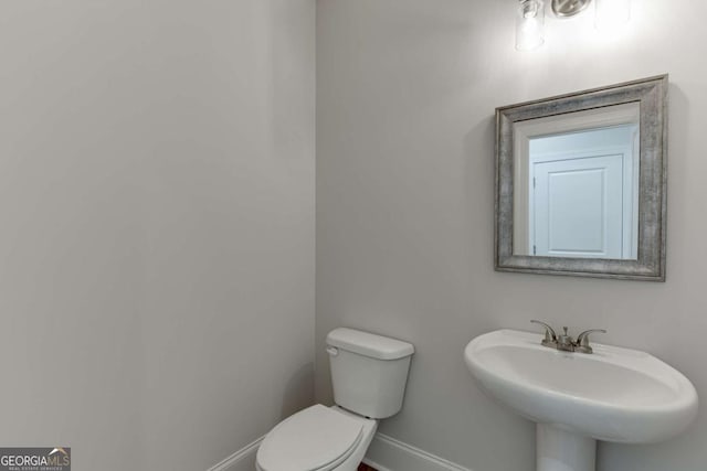 bathroom featuring sink and toilet