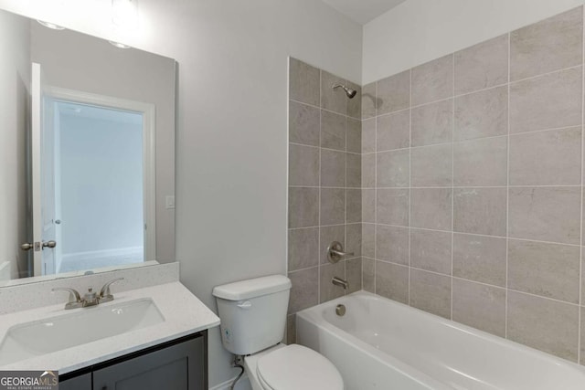 full bathroom featuring toilet, vanity, and tiled shower / bath